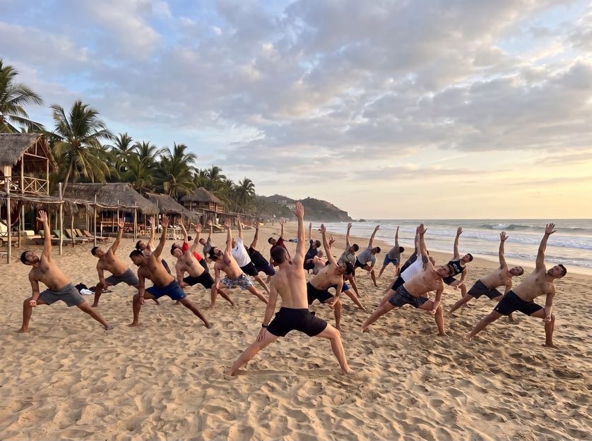 Men doing yoga on beach Zipolite Mexico